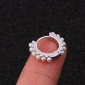 Elegant silver hoop earring with white pearls on a fingertip for size reference - Silver