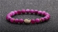 Detailed macro view of 8mm purple agate bead bracelet with golden Tai Chi yin yang charm - Rose Purple