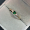 Elegant gold plated ring featuring a central green zircon and clear side stones - US 5 / Gold / Green Zircon