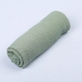 Sage green bali yarn scarf with crinkle texture and raw fringe edges for photography - Fruit Green