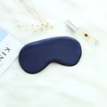 Dark blue satin sleep eye mask with adjustable buckle on a cozy white plush background - Adjustable Buckle Paper Card Packaging / Navy Blue