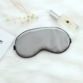 Adjustable silver grey faux silk sleep mask with black elastic strap on white plush rug - Adjustable Buckle Paper Card Packaging / Business Grey