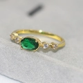 Vintage gold-plated ring with oval emerald gemstone and cubic zirconia accents - US 6 / 14K Light Gold Emerald Zircon