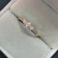 Elegant gold plated three-stone ring with clear zircons in a grey velvet jewelry box - US 6 / Gold / White Zircon