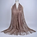Detail of tan lace shawl with hollow floral patterns and long fringe tassels - 180cmx60cm / Khaki