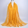 Close-up of bright yellow lace scarf with floral cutout patterns and long fringe tassels - 180cmx60cm / Yellow