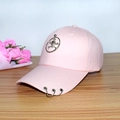 Pink baseball cap featuring metal skull ring and side hoop accents on a wooden table - Adult Adjustable 55-59cm / Skull Ring (Pink)