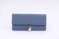 Detailed view of Morandi blue long wallet with white stitching and leaf pendant - Sapphire Blue