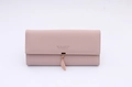 Detail of long mauve PU leather wallet featuring a leaf pendant and flap closure - Pink