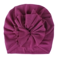 Macro detail of the pleated fabric and large 3D flower on the purple baby turban hat - Violet