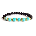 Detail van lavasteen kralen en turquoise armband met gouden metalen tussenstukjes - Blauwe Keizersteen