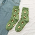 Women's green mid-calf cotton socks featuring avocado pattern with blue denim jeans - Avocado