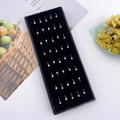 Detail view of 30 silver stainless steel nose studs with sparkling crystals in a box - Silver White Rhinestone