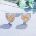 Elegant heart-shaped stud earrings with gold foil accents on a blue floral background - White Opal