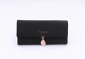 Close-up of black PU leather long wallet featuring a pink leaf charm and fine stitching - Black