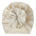 Close-up of a soft cream knitted baby turban hat with a large ruffled flower detail. - Beige