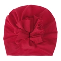 Detail shot of the large ruffled flower decoration on the soft red baby turban hat. - Red