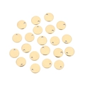 Detailed macro view of twenty small golden stainless steel round tags with pre-drilled holes - Inner Hole / 6mm / Gold