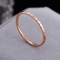 Slim rose gold titanium steel ring featuring a geometric diamond-cut textured surface - US 5 / Rose Gold Twill