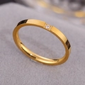 Minimalist gold titanium steel ring featuring a single small round clear crystal - US 5 / Gold