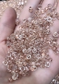 Mano con cierres de pendientes en silicona transparente con núcleo metálico de oro rosa - Oro rosa