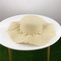 Beige woven straw hat with wavy brim and seashell decorative accents on a white table - M (56-58cm) / Beige - Wide Brim Wave Style
