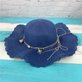 Navy blue woven straw sun hat featuring wavy edges and colorful floral pendant charms - Navy Blue