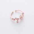 Detail of rose gold flower ring featuring micro-set cubic zirconia and a small pendant - 18#12960