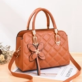 Brown quilted leather crossbody bag with a decorative bow and gold-tone round handle - Earthy Yellow