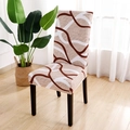 Stretch dining chair cover with brown and white abstract fluid pattern in a bright room - Alternative Life