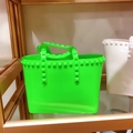 Detail of neon green PVC bucket bag featuring gold pyramid rockstuds and large capacity - Small / Fluorescent Green