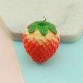 Macro detail of a 3D resin strawberry pendant with red gradient and green leaves - Large