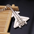 Close-up of a silver fighter jet keychain with detailed metallic textures on a stand - J-20 Stealth Fighter Jet (飞机10)