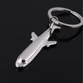 Sleek silver metal J-20 fighter jet airplane keychain on a minimalist black background - Stealth Bomber Style (飞机13)