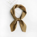 Detail of a brown silk-like square scarf tied in a knot on a white table backdrop - Grass Green