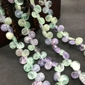Close-up of translucent purple and green fluorite teardrop beads on a vintage wooden box - 10mmx12mm / Natural Colorful Fluorite