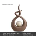Brown ceramic abstract art sculpture with a centered orb in a minimalist nordic style - Nordic Minimalist / Brown (Short)