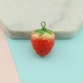 Detailed view of resin mini strawberry pendant with silver metal loop and green leaves - Small