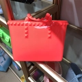 Vibrant orange jelly tote bag featuring classic pyramid studs on a durable PVC handle - Small / Red