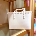 Detail shot of white jelly tote bag featuring signature pyramid rockstuds and top handles - Small / White