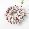 Detailed close-up of a floral scrunchie with vintage red roses on a beige fabric - Beige Floral