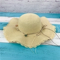 Beige woven straw sun hat with wavy brim and delicate small fabric flower decorations - Adult M / Beige