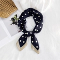 Elegant navy blue polka dot silk scarf with cream border in a flat lay vacation setting - Black Polka Dot