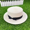 Top view of beige straw boater hat featuring a black ribbon band and elegant bow detail - M / With Bow / Creamy White