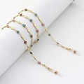 Golden eyewear chain with colorful evil eyes and star charms on a white cylinder - Gold Evil Eye Star Style (GL984)