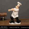 Vintage resin chef wine bottle holder with classic white uniform and checkered base - Chef with Red Wine
