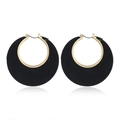 Close-up of geometric round wood earrings featuring black hollow hoops and golden metal accents - Black