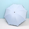 Blue and white striped sun umbrella with black trim in a fully unfolded state - Light Blue Ruffle Stripe