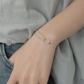 Minimalist silver double-strand bracelet with geometric circle charm on woman wrist - Simple Circle Minimalist Bracelet