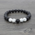 Detail of natural black lava stone and white turquoise beaded yoga bracelet texture - Synthetic White Jasper